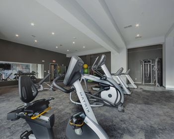 Fitness center with cardio and strength training equipment at Berlin Apartments, South Bend, IN